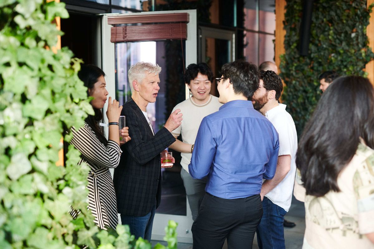 Guests talking at a speedrun mixer