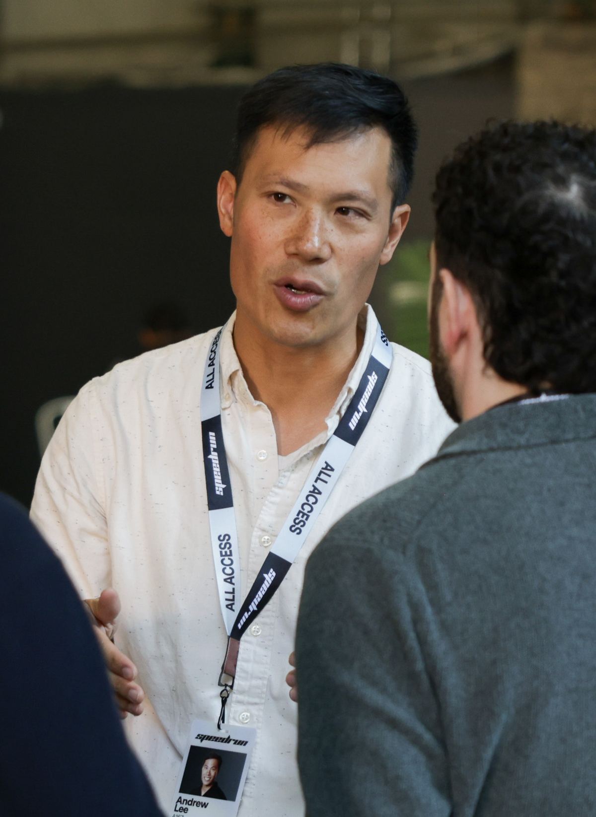 A speedrun team member talking with guests at an event