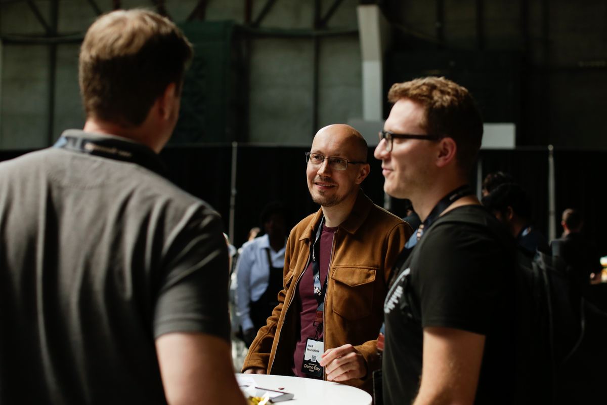 Investors in conversation at speedrun Demo Day